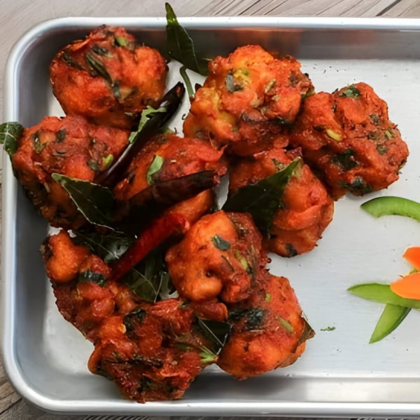 Spice Venue's Indian chicken pakora, deep-fried and spiced, garnished with curry leaves and chilies.