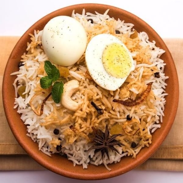 Spice Venue's egg biryani with whole and halved boiled eggs, cashews, mint, and spices.